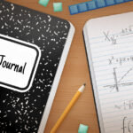 An open math journal on a desk.