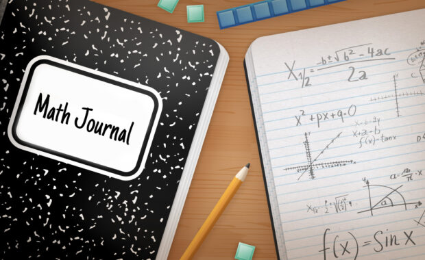 An open math journal on a desk.