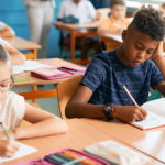 Students working on a writing assignment in a classroom.