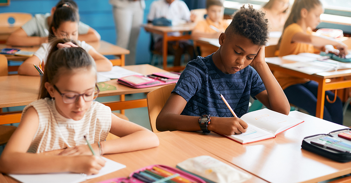 Students working on a writing assignment in a classroom.