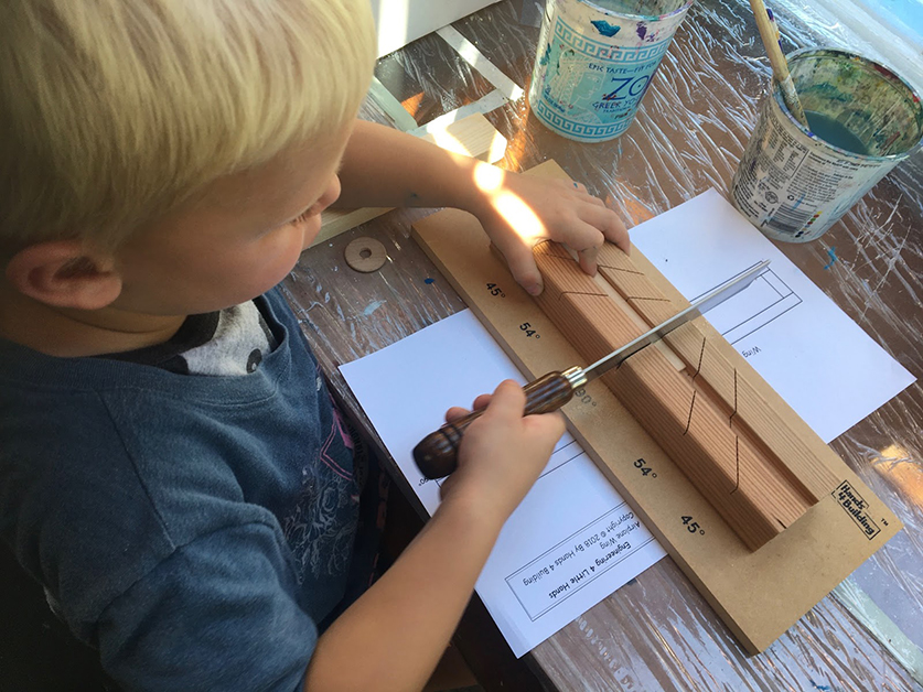 A young boy works on a model building set.