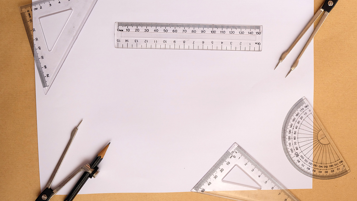 An assortment of tools used for measurement, including a ruler and protractor.