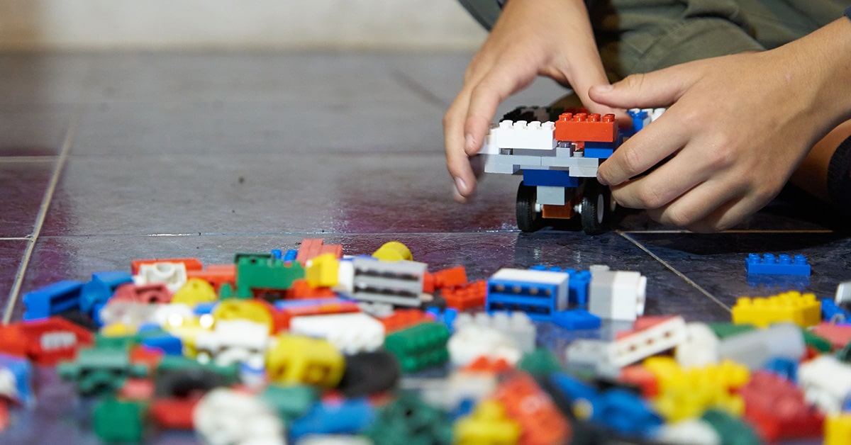 Child playing with LEGOS.