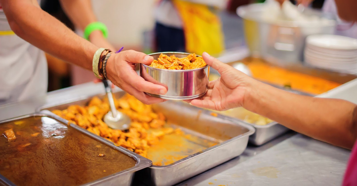 Volunteers serving a meal.