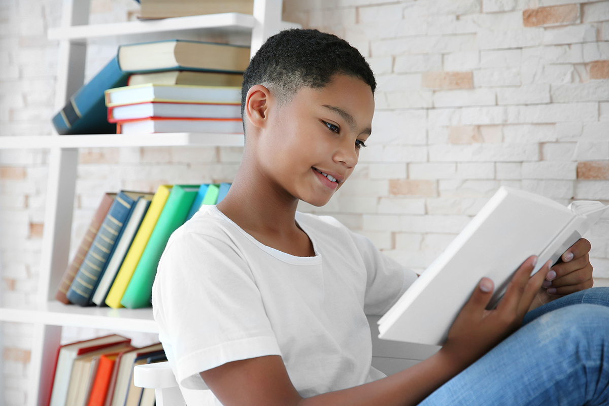 A young boy reads a book.