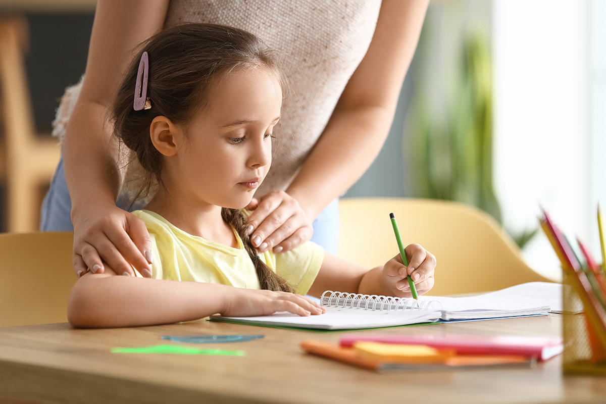 A mother helping her daughter with homework.