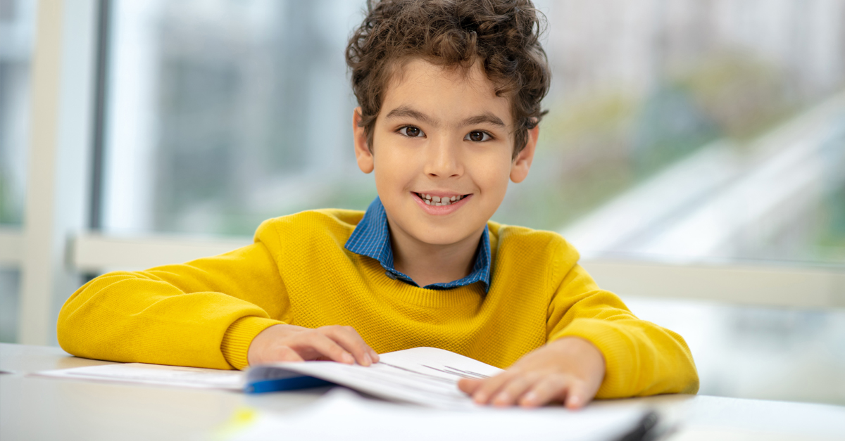 A young boy doing homework.
