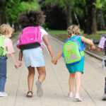 A group of students walk to school together.