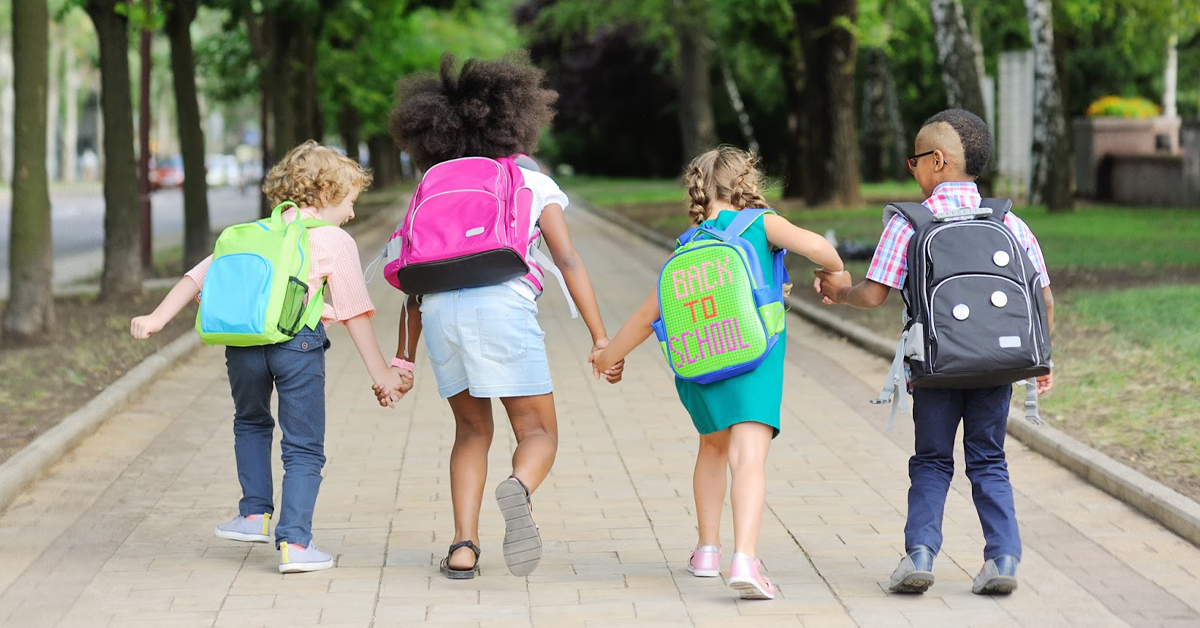 A group of students walk to school together.