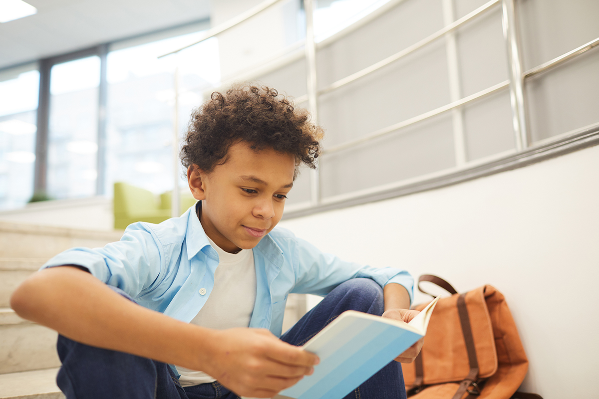 A young boy reading a book.