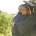 Father hugging his son on his graduation day.
