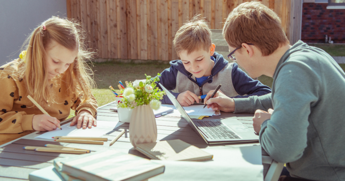 Homeschool students learning outside.