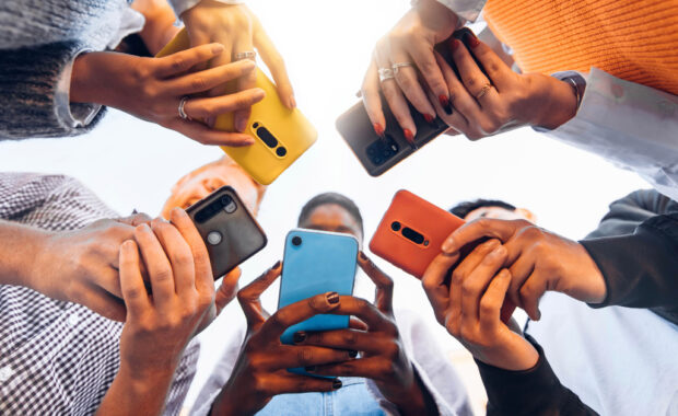 A group of people using smartphones.