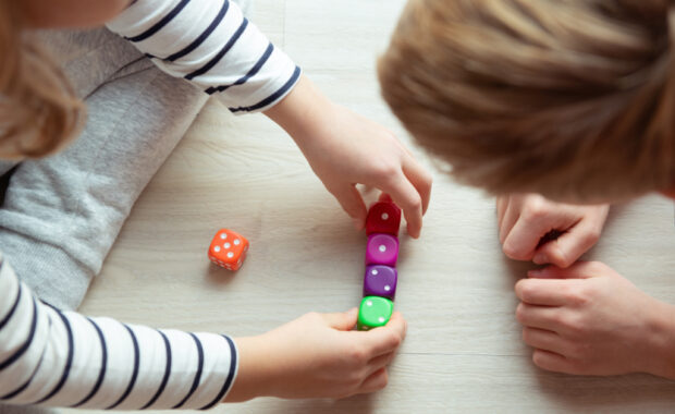 Students playing a math game with dice.