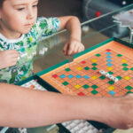 A family playing a board game with letters.