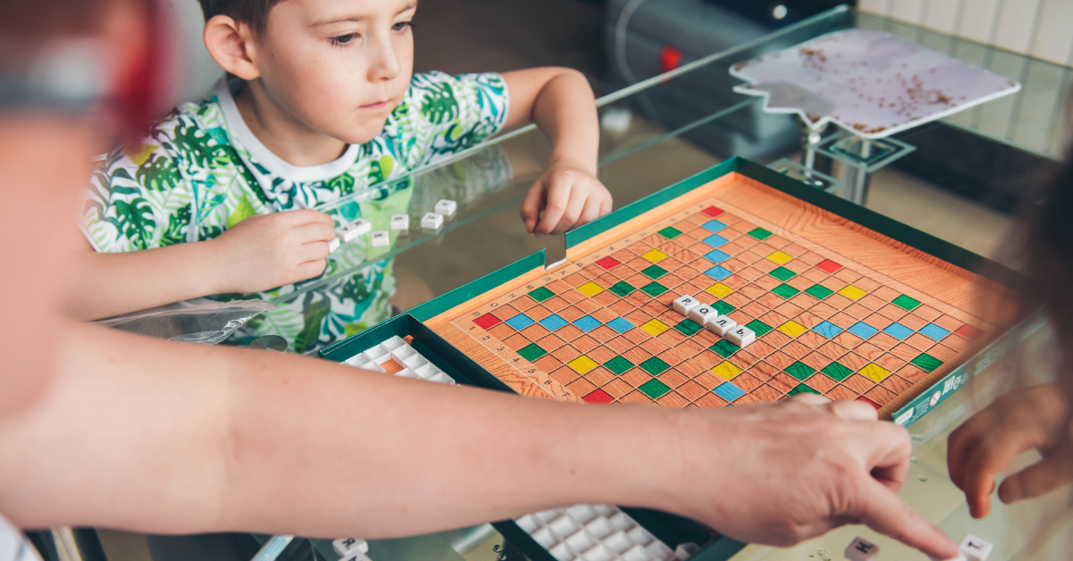A family playing a board game with letters.