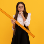 A math student holding a ruler.