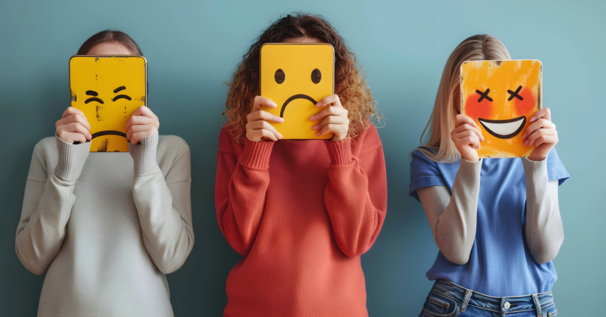 People holding emojis in front of their faces.