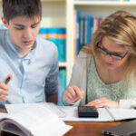 An instructor and student working on schoolwork together