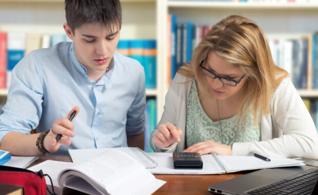 An instructor and student working on schoolwork together