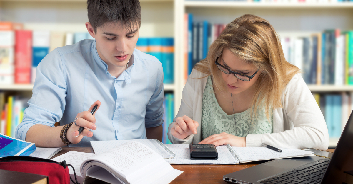 An instructor and student working on schoolwork together