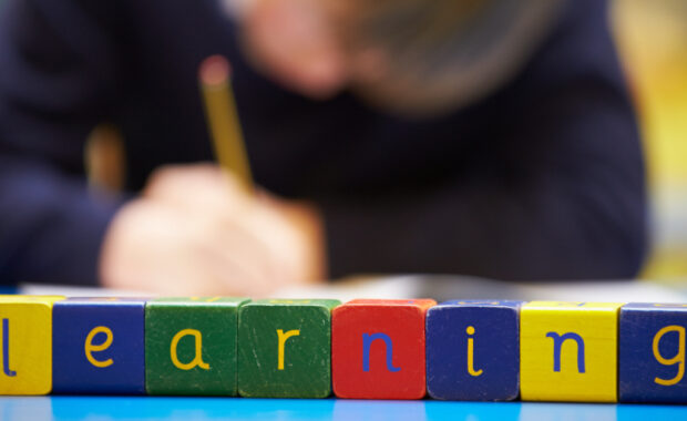 Playing blocks that spell "Learning"