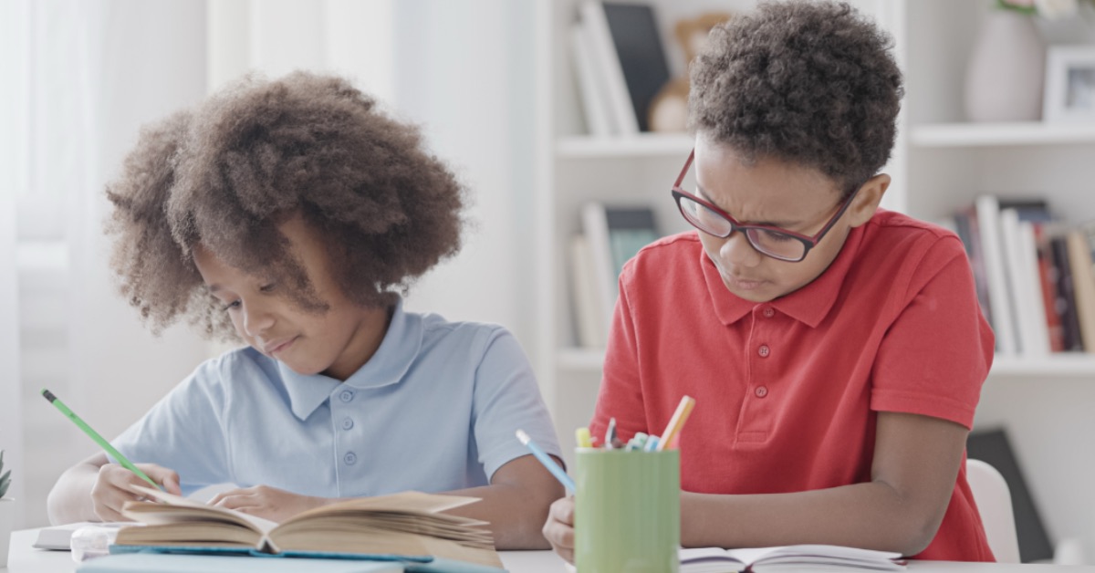 Two students reading and writing