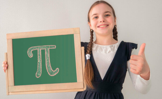 A student holding a chalkboard with the symbol for pi on it