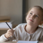 A student writing on a piece of paper