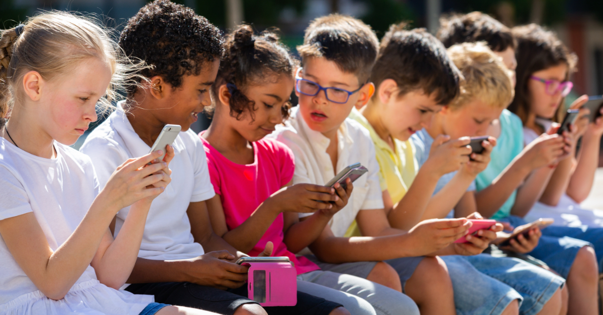A group of children looking at mobile device screens