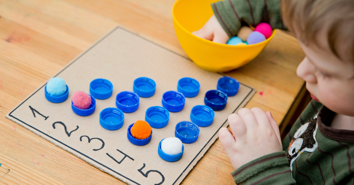 A young student doing sensory math play