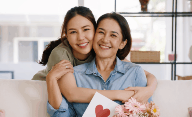 A parent and child sitting on a couch together.