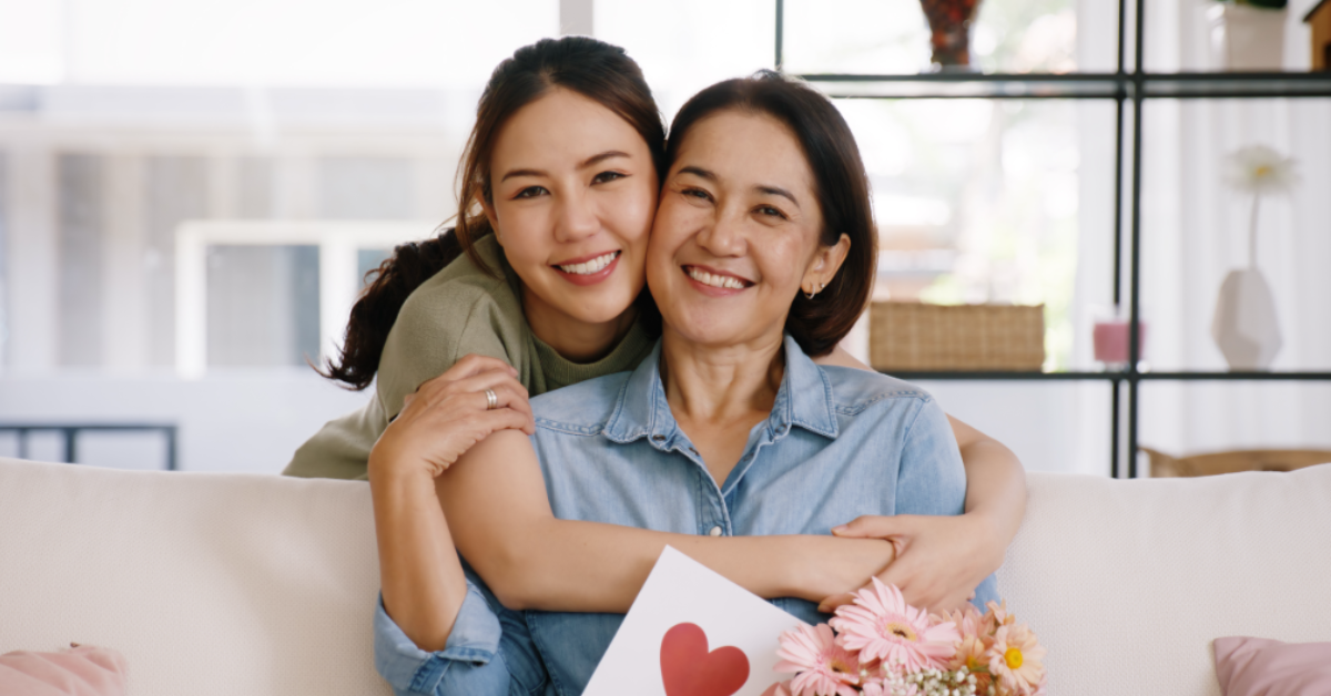 A parent and child sitting on a couch together.