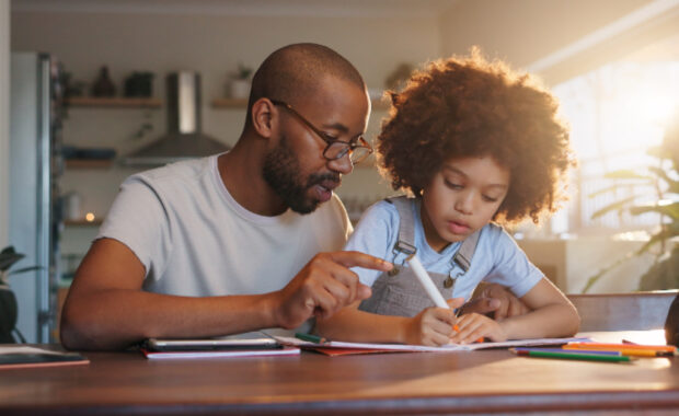 A father and son doing math homework together