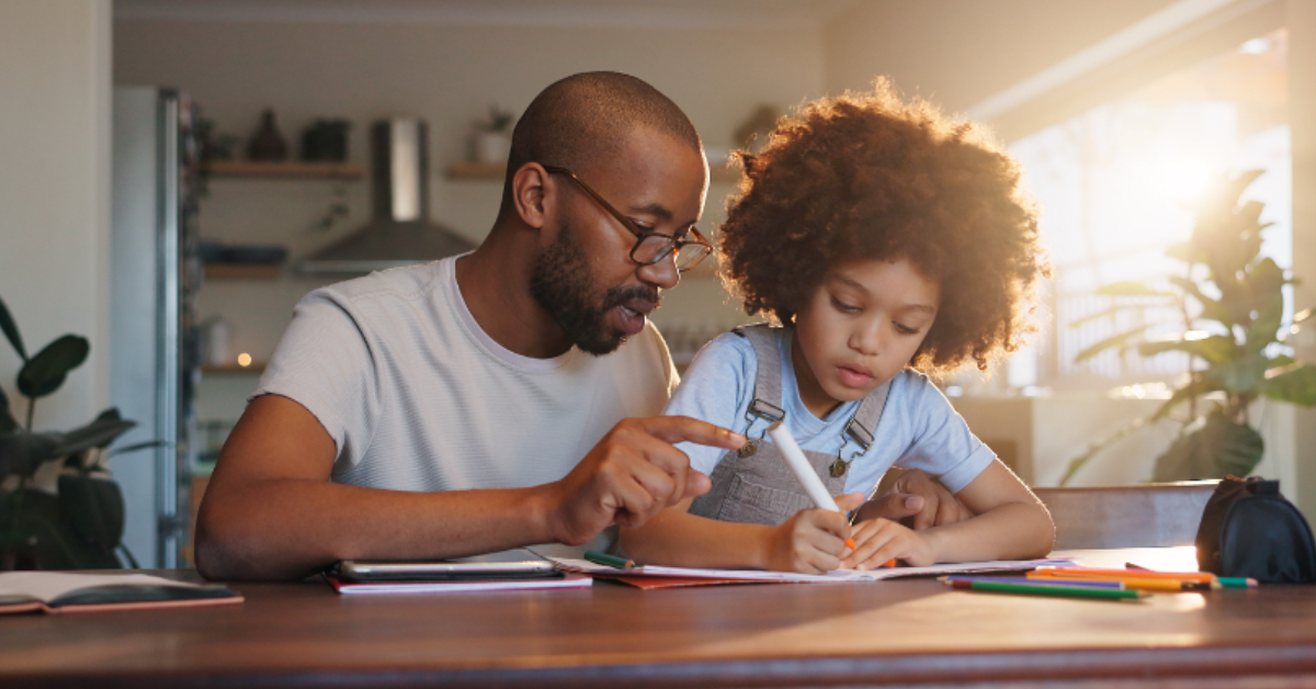 A father and son doing math homework together