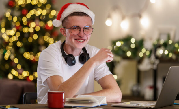 A student doing homework wearing a Santa Claus hat