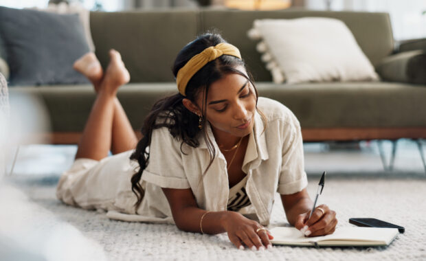 A student writes on a notepad