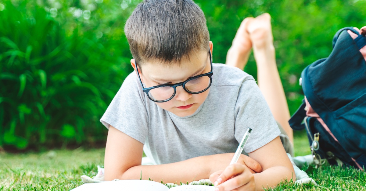 A student writing outside