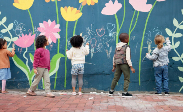A group of students painting a mural