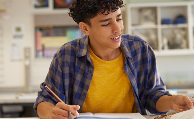A student writing on a piece of paper