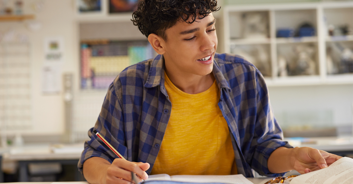 A student writing on a piece of paper