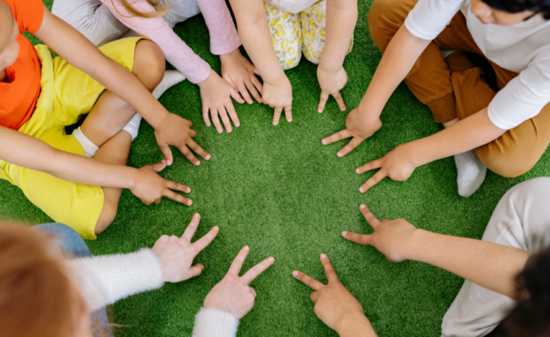 A group of students counting numbers on their fingers