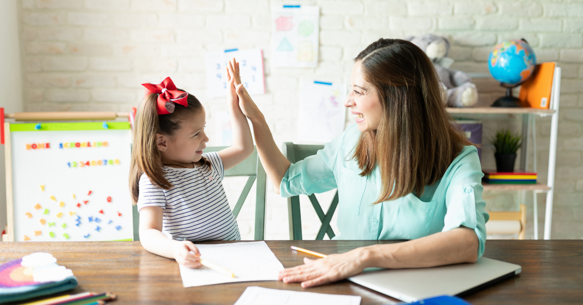 A homeschool teacher and student doing homework together