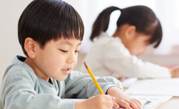 Students writing with pencils
