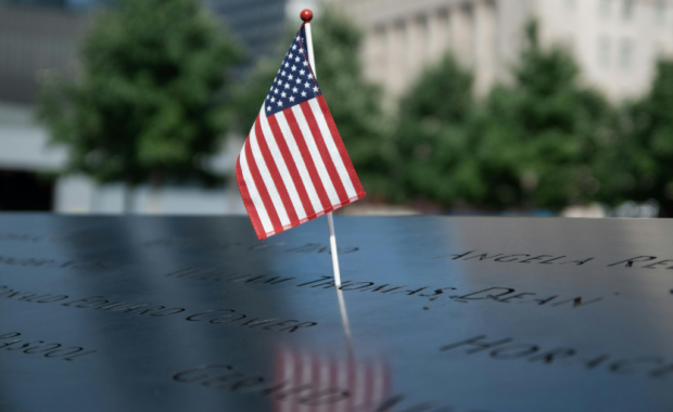 An American flag over a memorial