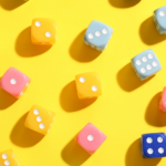 A large amount of 6-sided dice on a table.