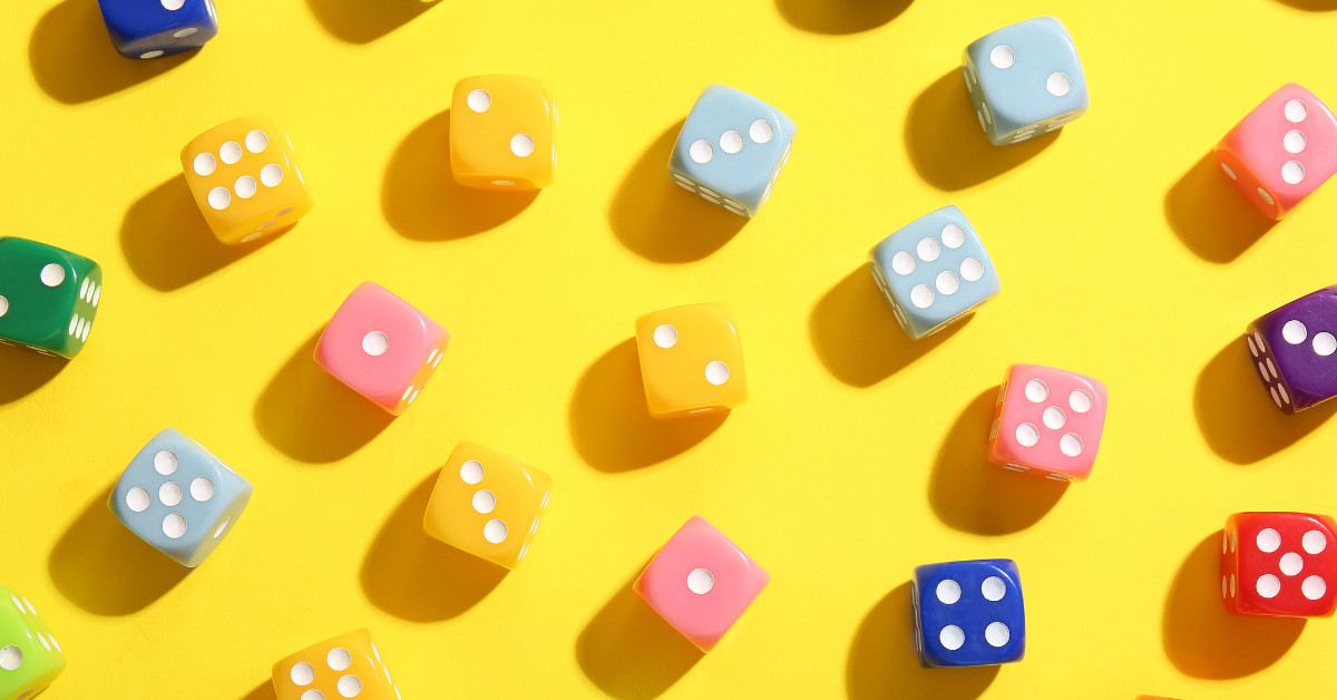 A large amount of 6-sided dice on a table.
