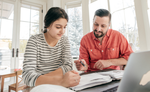A parent helping their child with homework