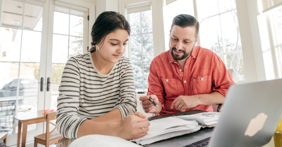 A parent helping their child with homework